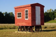 Exiled Installation, wooden House, 30 legs made of of polyester and painted, 2015